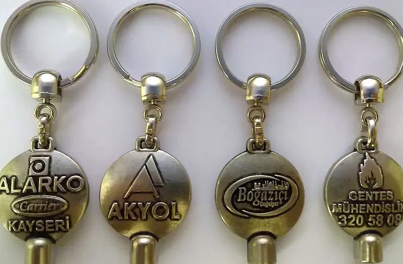 promosyon dört altın renkli metal anahtarlık, yuvarlak gövde, üstte halka, altta silindir uç